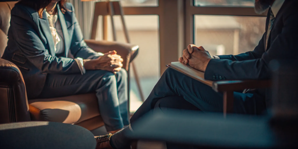 Personal injury attorney consulting with a client in a New Mexico law office, reviewing case documents together